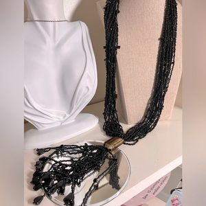 N320 Multi strand necklace of black beads, gold flake glass bead, bead tassel…